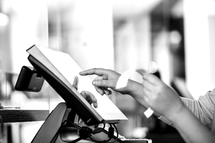 a person is using a pos machine in a store